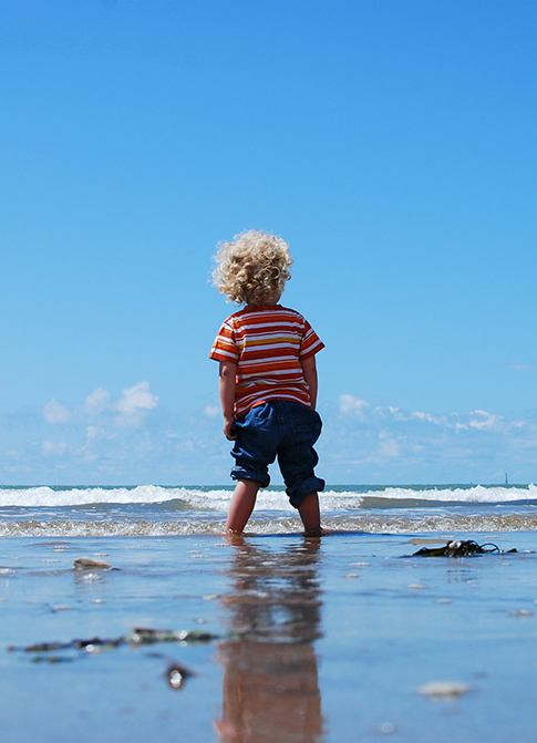 Child on the beach in the water