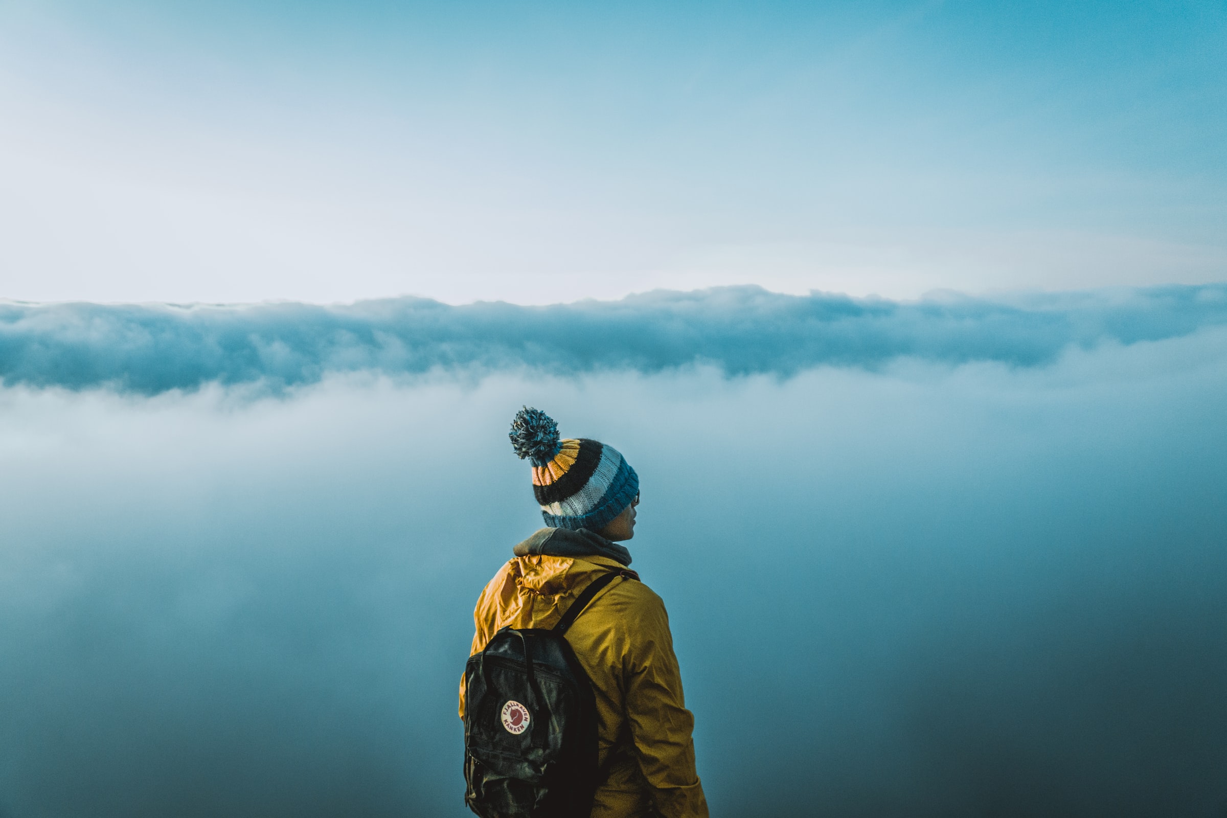 Backpacking traveler in the clouds